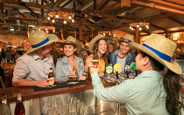 Guests enjoying drinks at the Australian Outback Spectacular Heartland Dinner & Show bar.