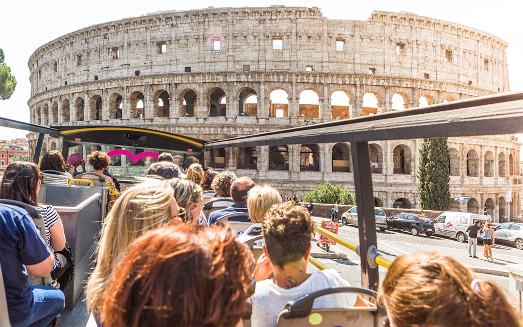 Tourists on a bus near the Colosseum in Rome.