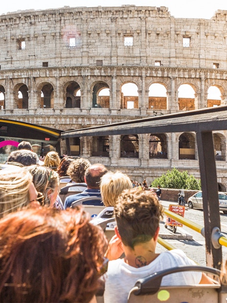 Tourists on a bus near the Colosseum in Rome.
