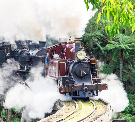 Steam train crossing a trestle bridge on the Puffing Billy Railway, Melbourne.