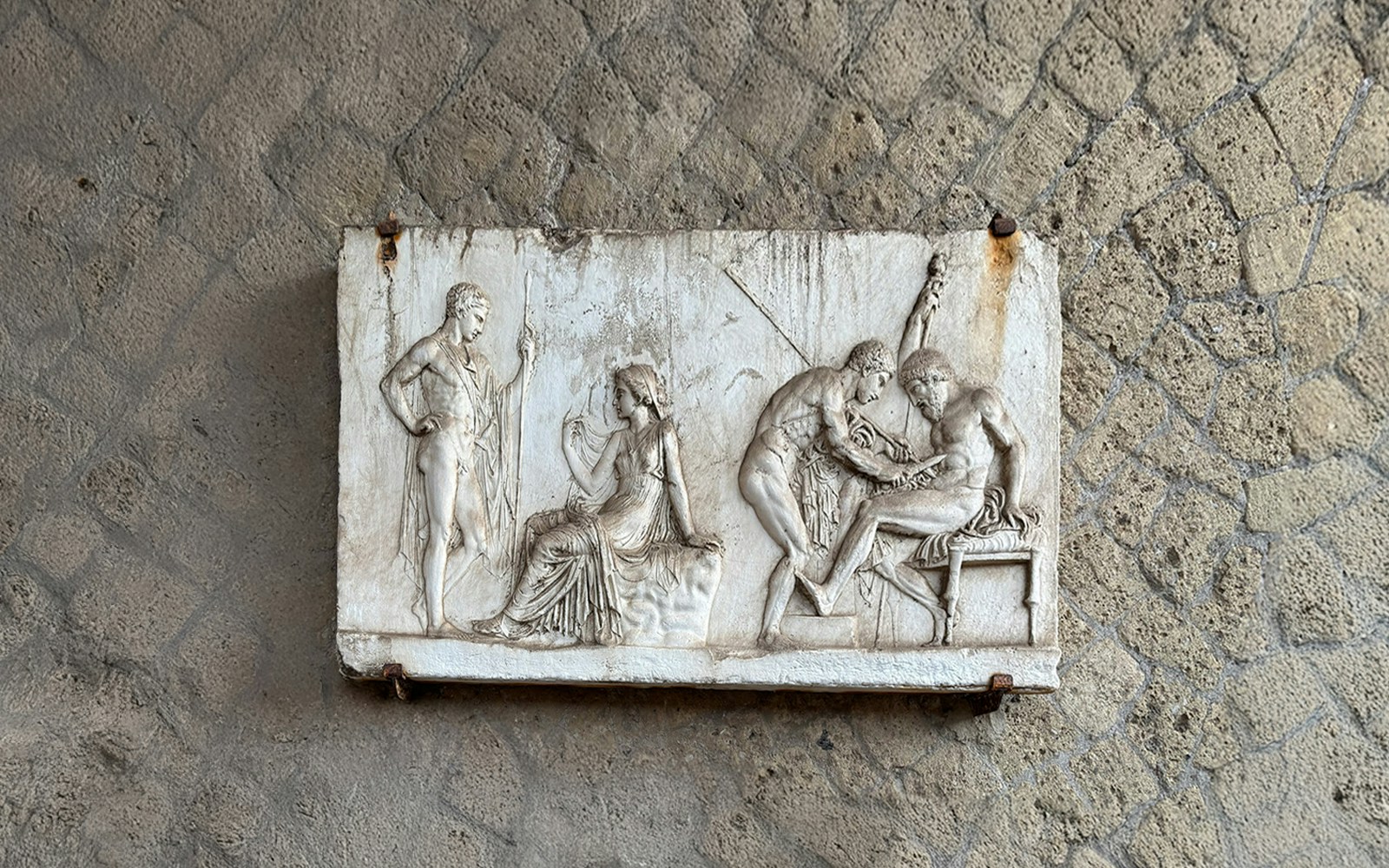 Ancient relief sculpture depicting figures in Herculaneum archives.