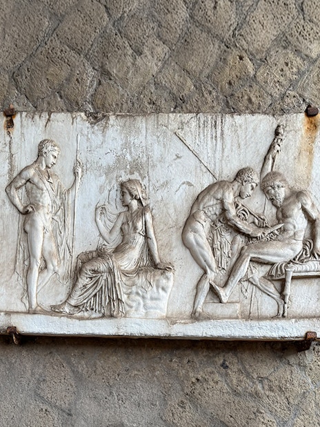Ancient relief sculpture depicting figures in Herculaneum archives.