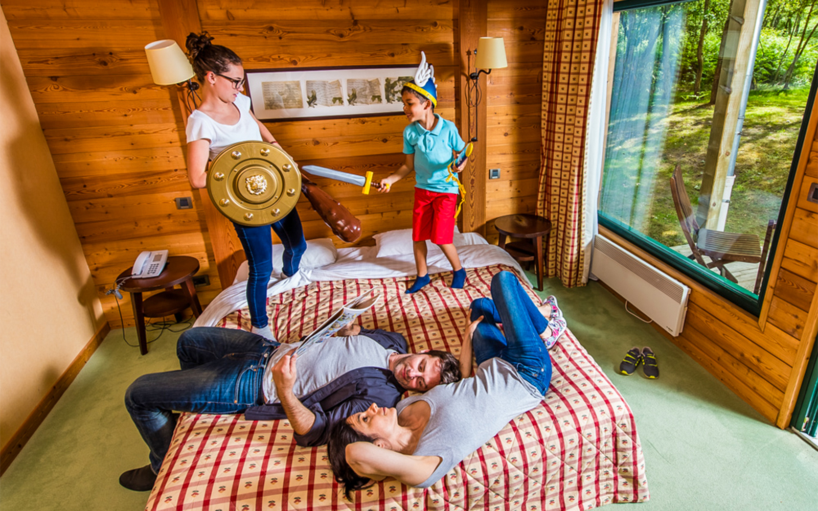 Parc Asterix hotel room with themed architecture and lush gardens in Plailly, France.