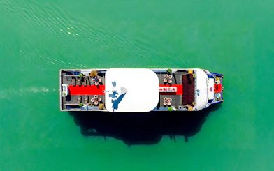 Aerial view of a boat with a red carpet and seating on the Deck of Harmony.