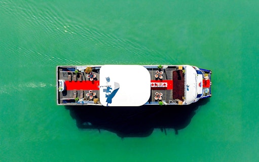 Aerial view of a boat with a red carpet and seating on the Deck of Harmony.