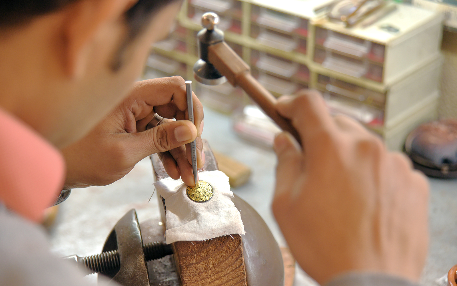 Sword and Damascene artisan crafting in Toledo workshop.