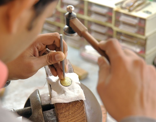 Sword and Damascene artisan crafting in Toledo workshop.