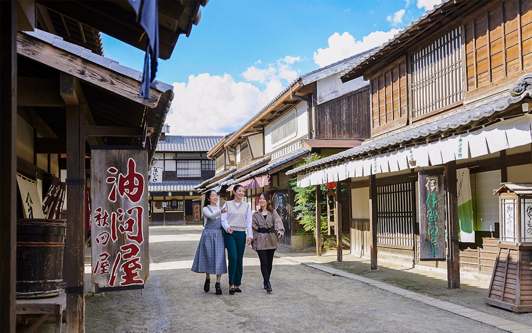 Visitors walking through traditional Edo-period street at TOEI Kyoto Studio Park.