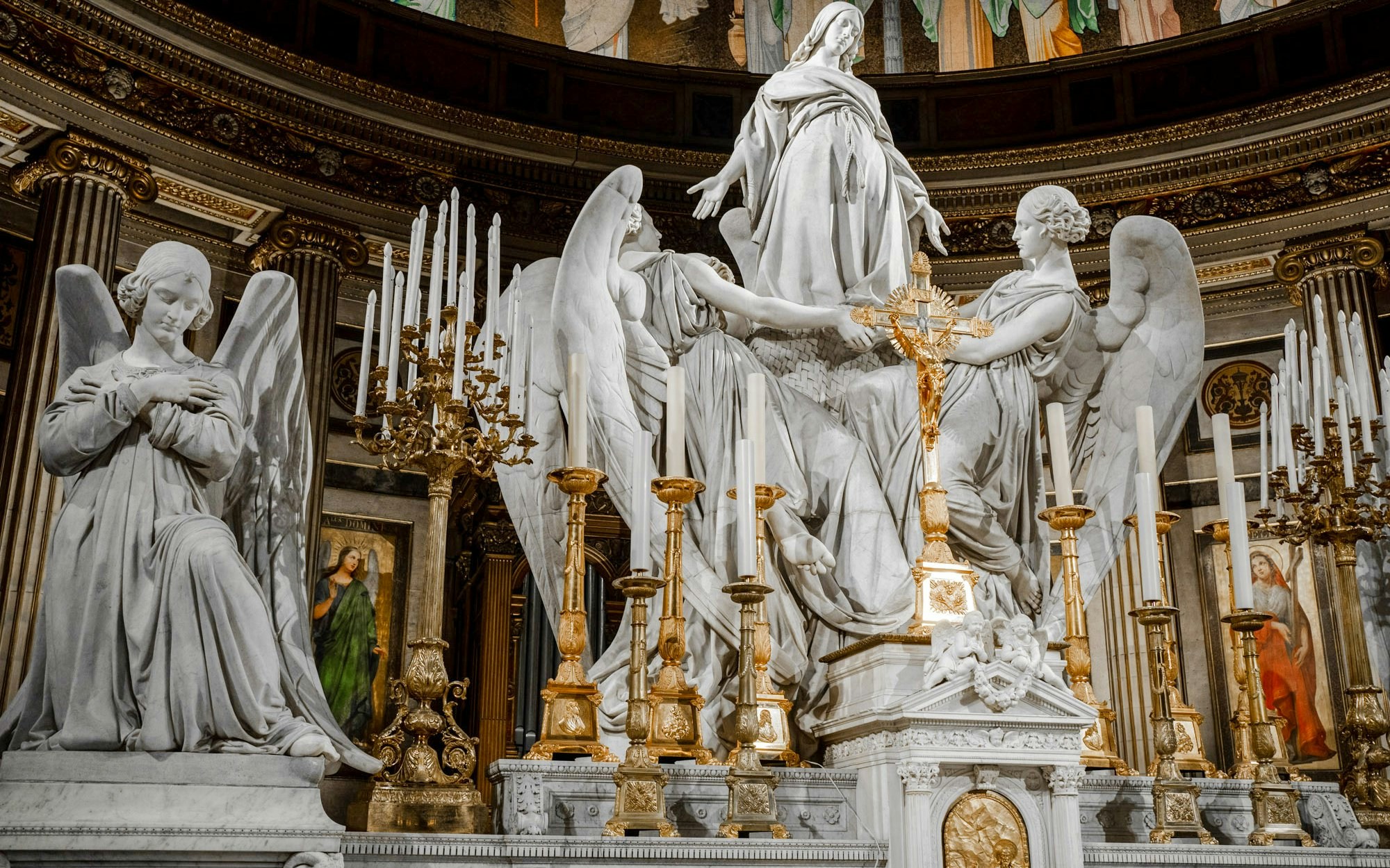 Statues and ornate altar inside The Church of St Madeleine, Paris, France.