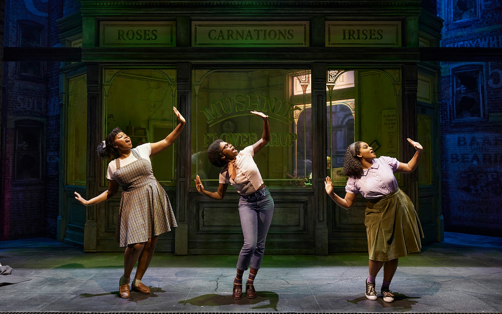 Performers dancing in front of Mushnik's flower shop in "Little Shop of Horrors" stage production.