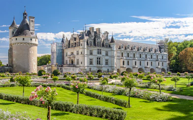 Chenonceau Castle with gardens on a sunny day in France.