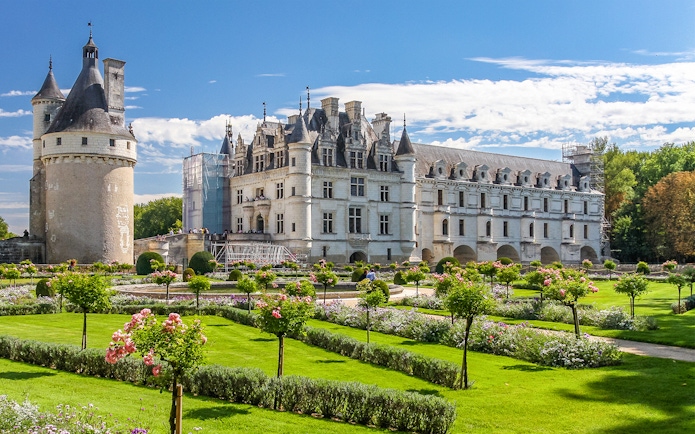 Chenonceau Castle with gardens on a sunny day in France.