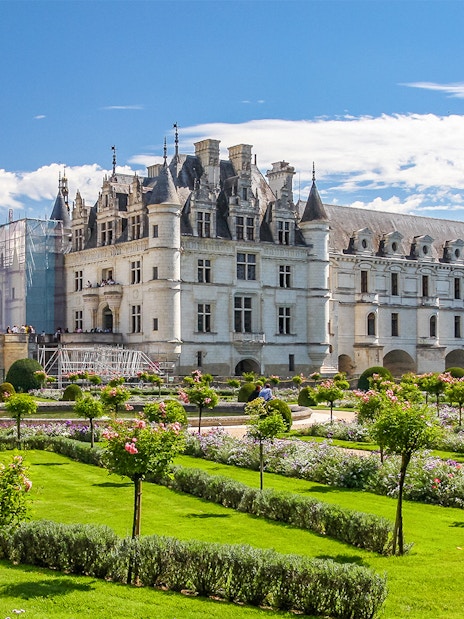 Chenonceau Castle with gardens on a sunny day in France.
