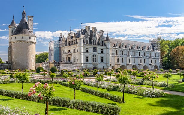 Chenonceau Castle with gardens on a sunny day in France.