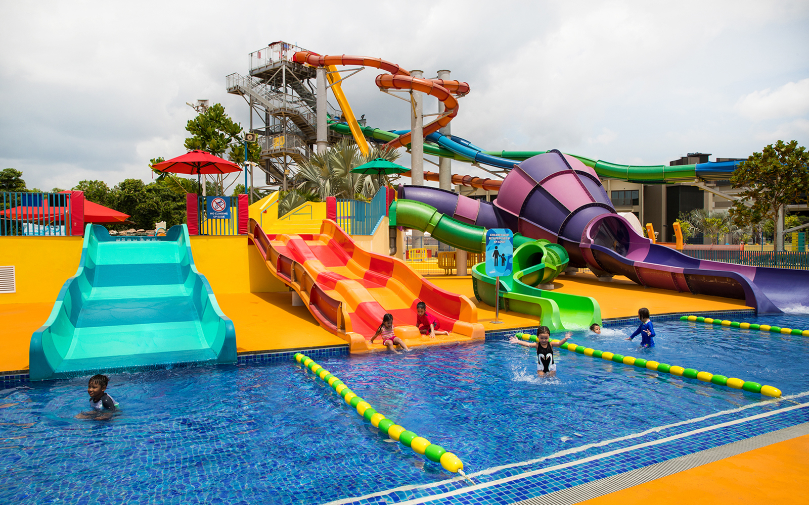 Children playing on colorful water slides at Wild Wild Wet, Singapore.