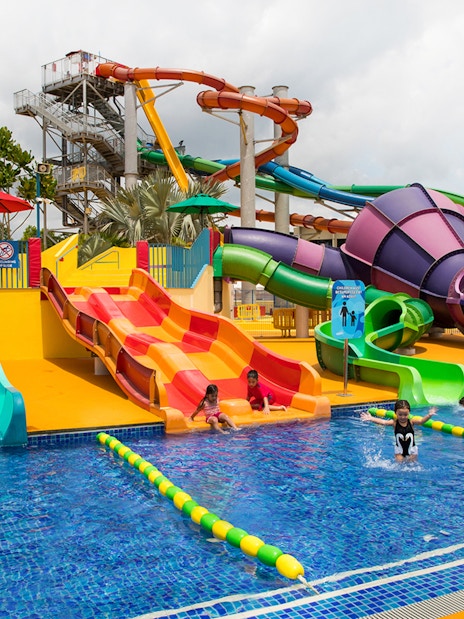 Children playing on colorful water slides at Wild Wild Wet, Singapore.