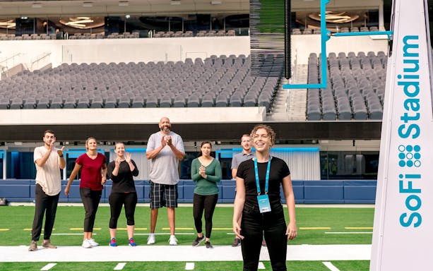 Group enjoying a guided tour on the field of SoFi Stadium.