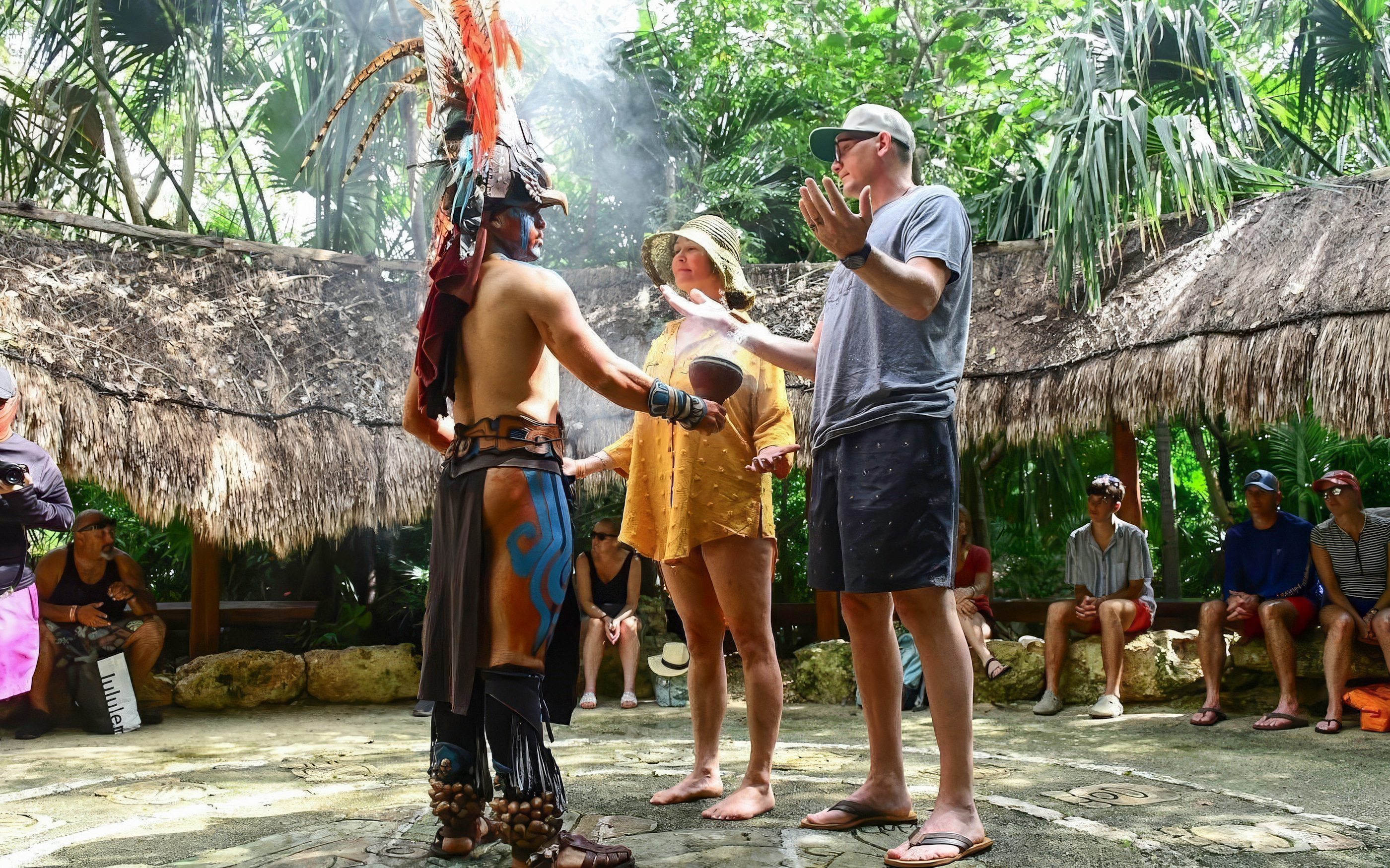 Couple participating in a traditional ceremony with a local guide in Cancun.