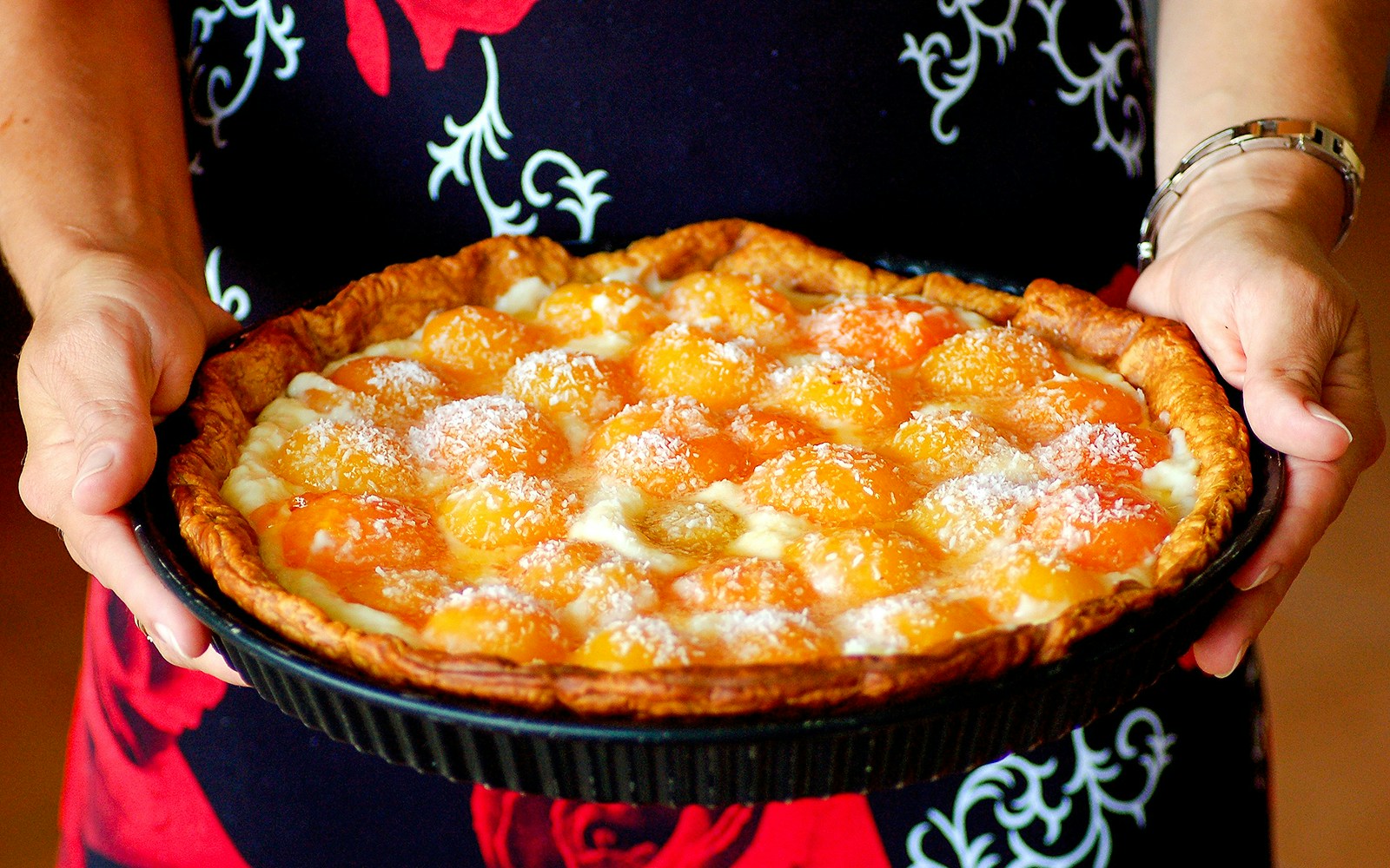 Tarte aux abricots held by a person in Paris.