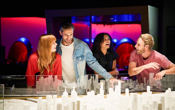 Group enjoying Melbourne Skydeck experience with city model display.