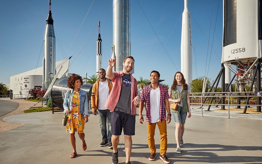 Visitors walking among rockets at Kennedy Space Center, Florida.