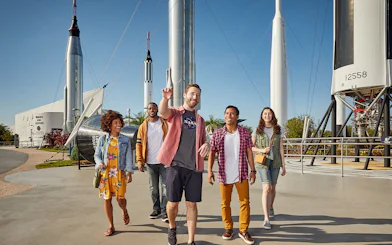 Visitors walking among rockets at Kennedy Space Center, Florida.