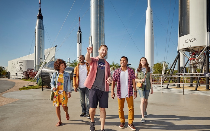 Visitors walking among rockets at Kennedy Space Center, Florida.