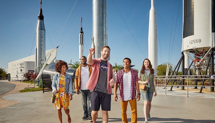 Visitors walking among rockets at Kennedy Space Center, Florida.
