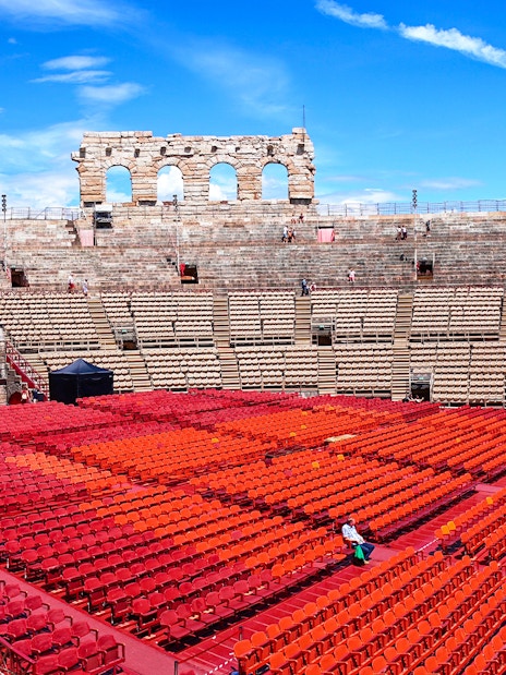 Verona Arena Italy with tourists exploring ancient Roman amphitheater architecture.