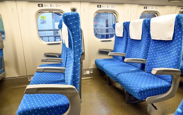 Train seats for Narita International Airport transfer in Japan.