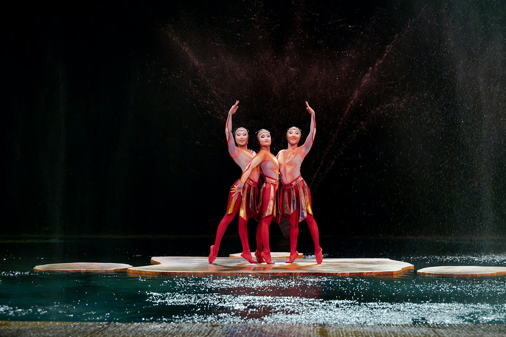 Performers in vibrant costumes on stage at Cirque du Soleil 'O' in Nevada.