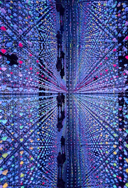 Colorful light installation at Moco Museum Barcelona with mirrored reflections.