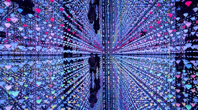 Colorful light installation at Moco Museum Barcelona with mirrored reflections.