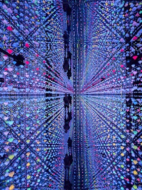 Colorful light installation at Moco Museum Barcelona with mirrored reflections.