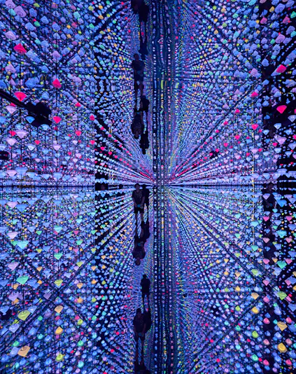 Colorful light installation at Moco Museum Barcelona with mirrored reflections.