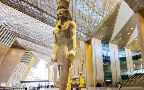 Grand Egyptian Museum interior with large pharaoh statue, Cairo.