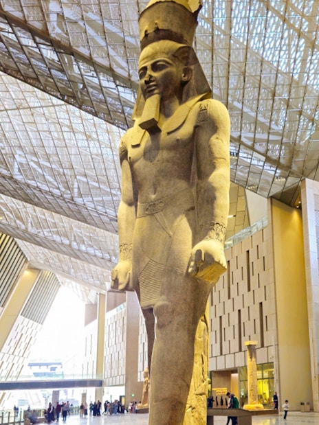 Grand Egyptian Museum interior with large pharaoh statue, Cairo.