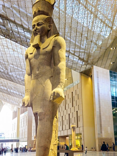 Grand Egyptian Museum interior with large pharaoh statue, Cairo.