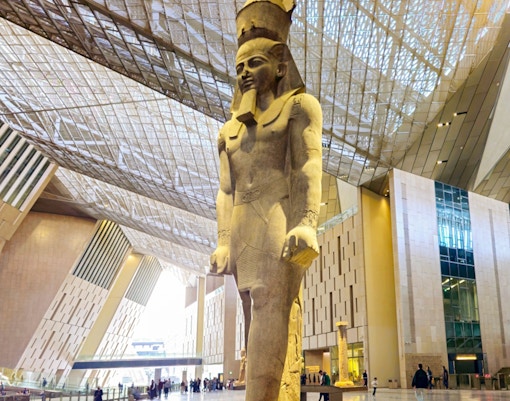 Grand Egyptian Museum interior with large pharaoh statue, Cairo.
