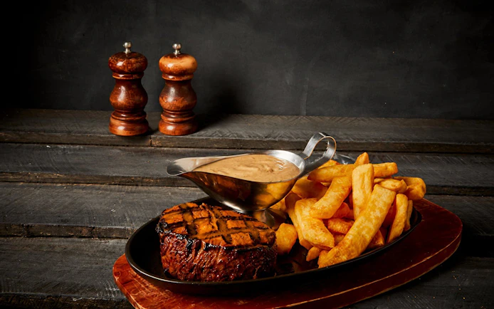 Grilled fillet with fries and sauce on Tomb of the Pharaoh Sunset tour.