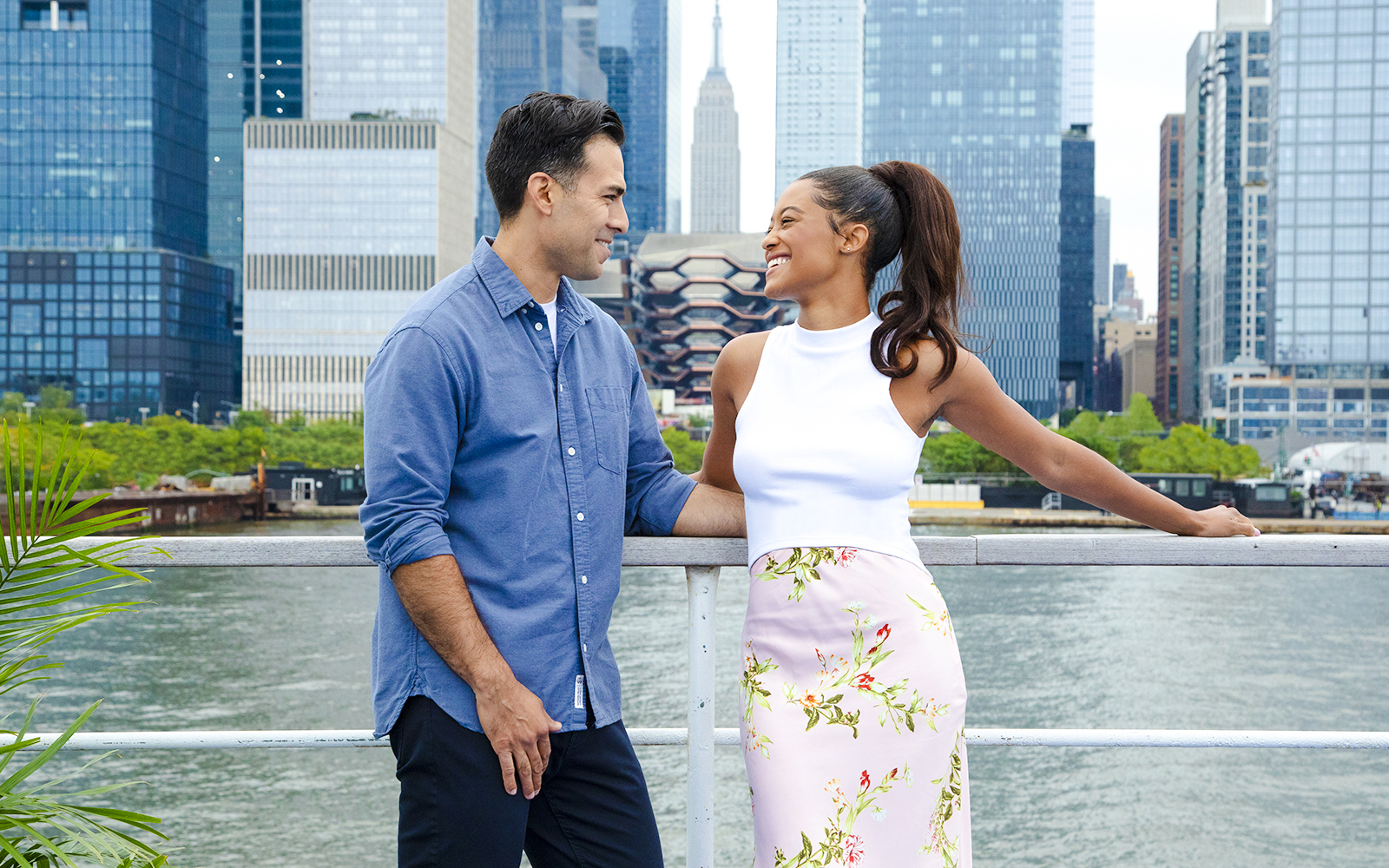 Couple enjoying New Jersey Signature Cruise with New York City skyline in background.