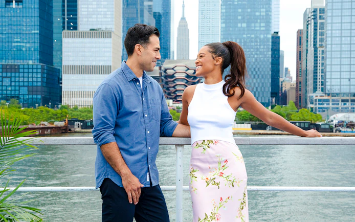 Couple enjoying New Jersey Signature Cruise with New York City skyline in background.