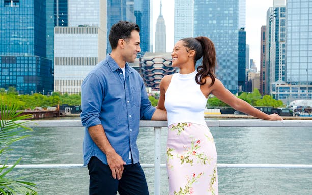 Couple enjoying New Jersey Signature Cruise with New York City skyline in background.