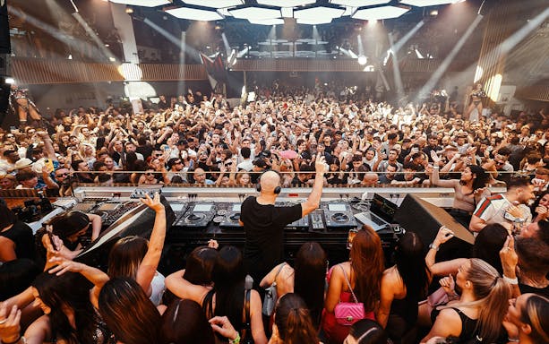 DJ performing at Music On event in Pacha Ibiza nightclub with vibrant crowd.