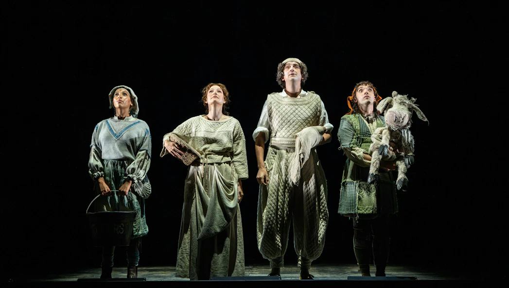 Four actors in medieval costumes on stage during "Into the Woods" performance.