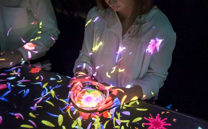Interactive digital art display at teamLab SuperNature Macau with colorful projections.