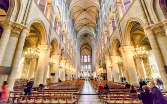 Notre-Dame interior with vaulted ceilings and chandeliers during treasury tour.