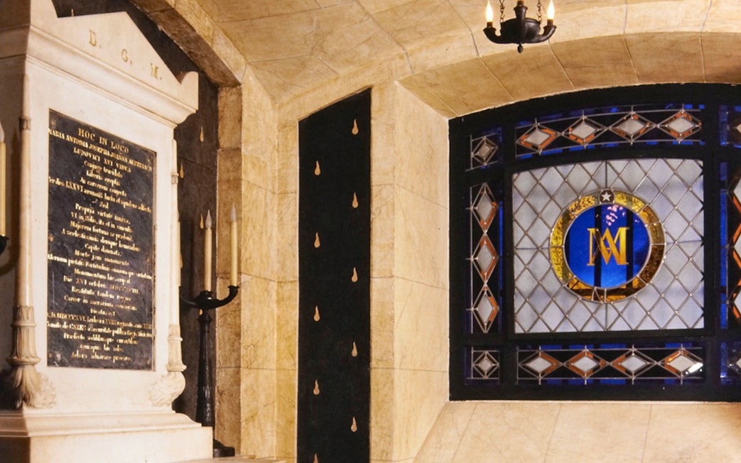 Stained glass window and stone plaque inside Conciergerie, Paris.