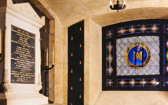 Stained glass window and stone plaque inside Conciergerie, Paris.