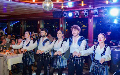 Dancers performing on a Bosphorus dinner cruise with live entertainment.